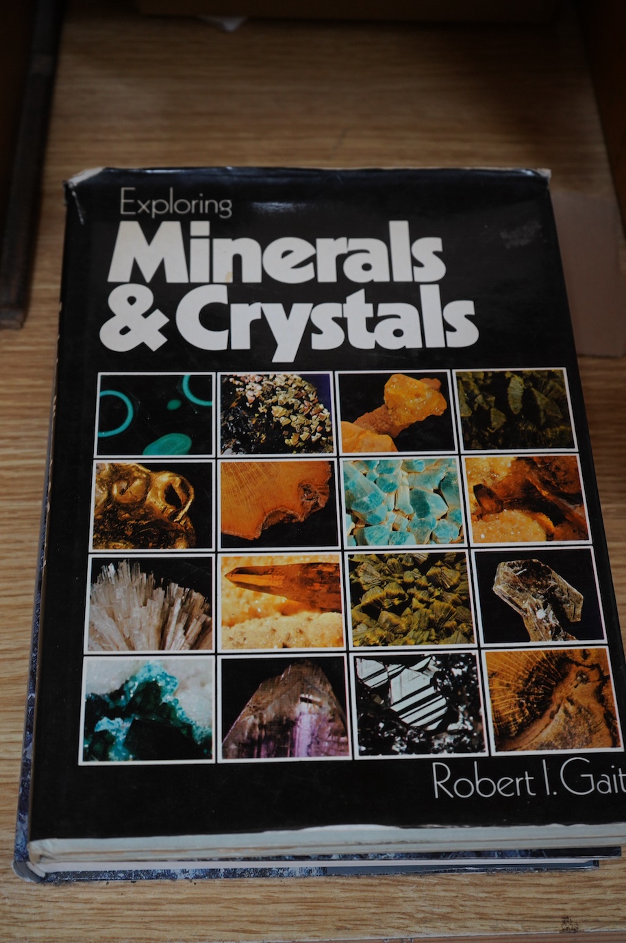 A collection of shells, rocks and specimen stones including; coral fragments, ammonites, quartz samples and other minerals, an echinoid, a selection of shells and a few reference books, most contained within two collecto